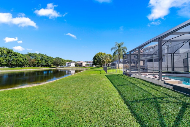 view of yard with a water view and a lanai