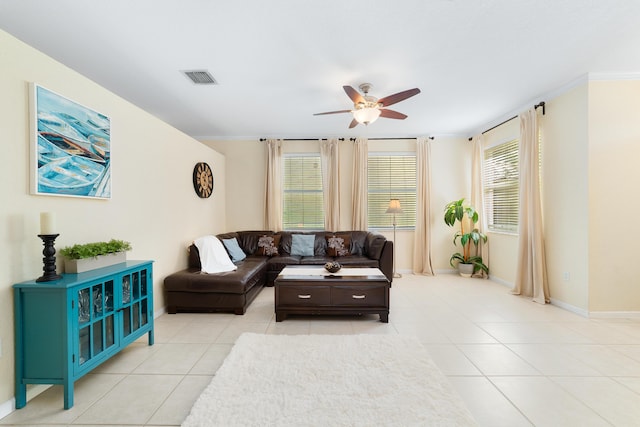 tiled living room with crown molding and ceiling fan