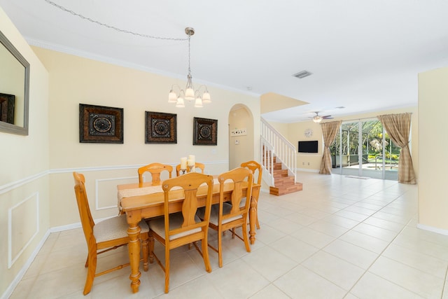 dining room with crown molding, light tile patterned flooring, and ceiling fan with notable chandelier