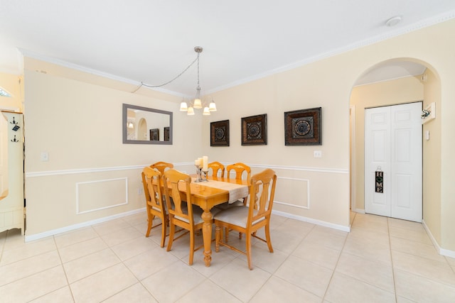 dining space featuring ornamental molding, a chandelier, and light tile patterned floors