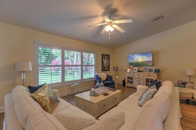 living room featuring hardwood / wood-style flooring, lofted ceiling, and ceiling fan