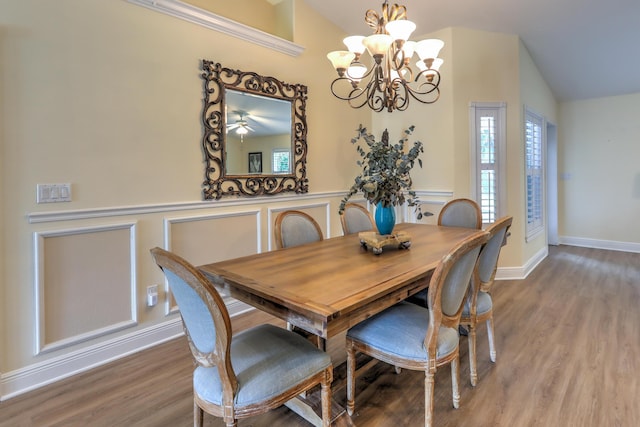 dining area with hardwood / wood-style flooring, a healthy amount of sunlight, and lofted ceiling