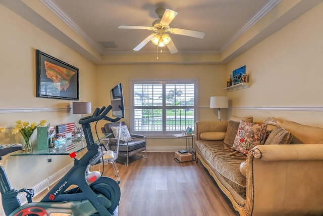 workout area with crown molding, wood-type flooring, and ceiling fan