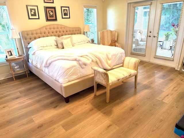 bedroom with hardwood / wood-style flooring, access to exterior, and french doors