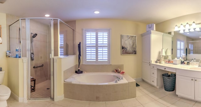 full bathroom featuring vanity, shower with separate bathtub, a healthy amount of sunlight, and toilet