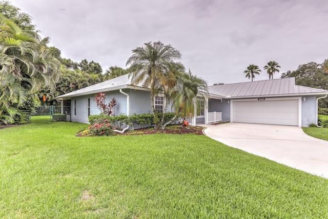 ranch-style home with a garage and a front lawn