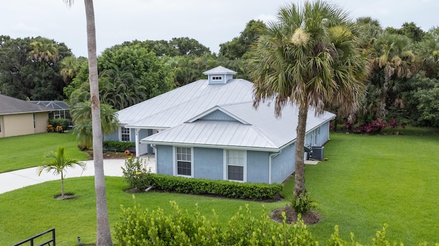 view of property exterior featuring a yard and central AC unit