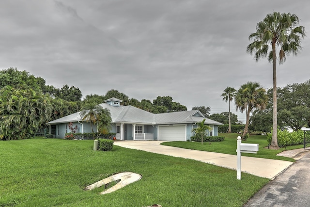 single story home featuring a garage and a front lawn