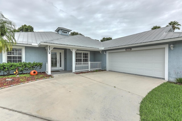 ranch-style home featuring a porch and a garage