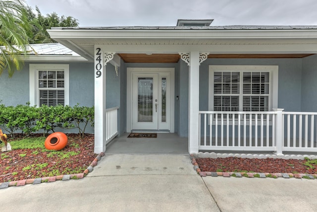 view of exterior entry with covered porch