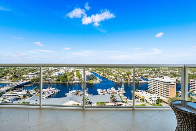 balcony featuring a water view and a city view