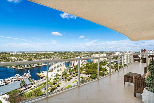 balcony featuring a water view and a city view