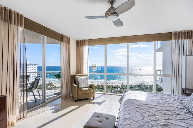 bedroom with access to exterior, a water view, and a beach view