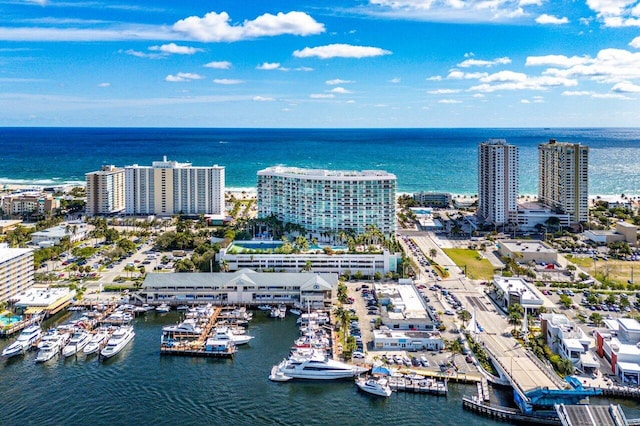 birds eye view of property featuring a water view and a city view