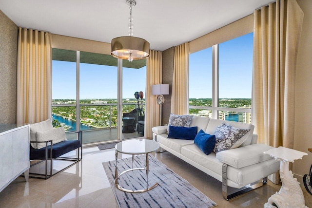 living room with light tile patterned floors and a water view