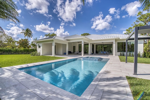 view of swimming pool with ceiling fan, a patio area, and a lawn