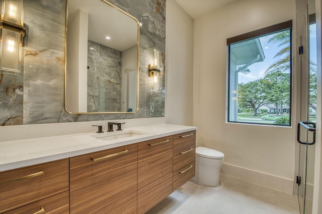 bathroom with tile patterned flooring, vanity, toilet, and a shower with shower door