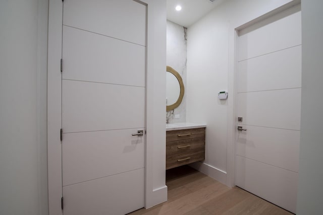 bathroom with vanity and wood-type flooring