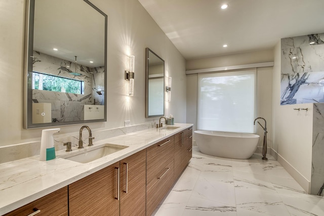 bathroom with vanity and a washtub