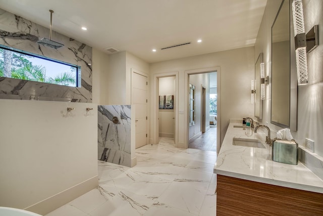 bathroom featuring walk in shower and vanity