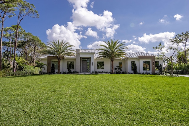 mediterranean / spanish home featuring a front lawn