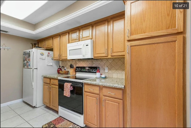 kitchen featuring light stone counters, white appliances, decorative backsplash, and light tile patterned flooring