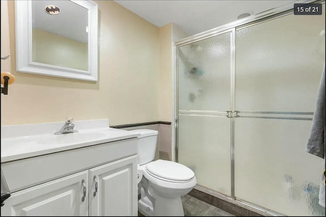 bathroom with vanity, walk in shower, and toilet