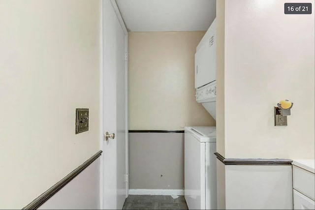 laundry area featuring stacked washer / dryer