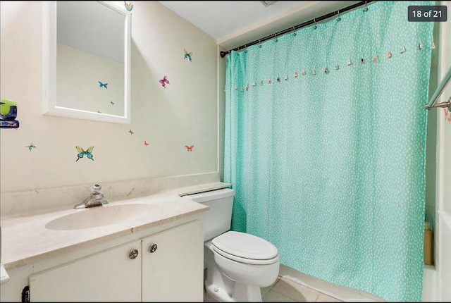 full bathroom with vanity, shower / bath combo, tile patterned floors, and toilet