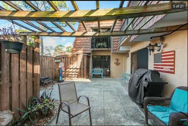 view of patio featuring area for grilling and a pergola