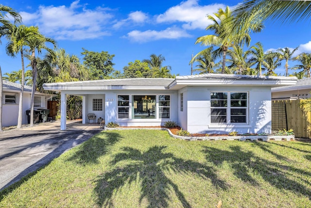 rear view of house featuring a yard and a carport