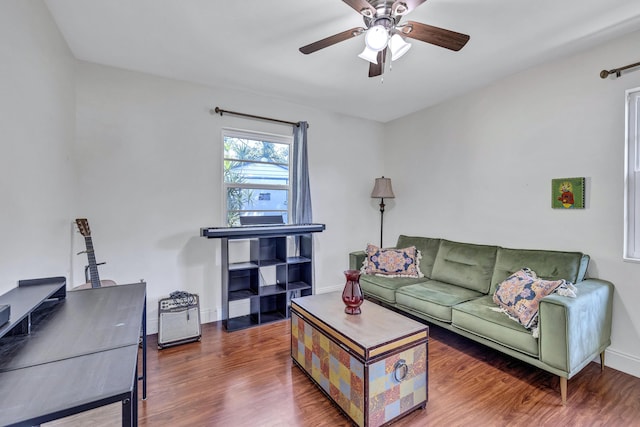 living room with ceiling fan and dark hardwood / wood-style floors