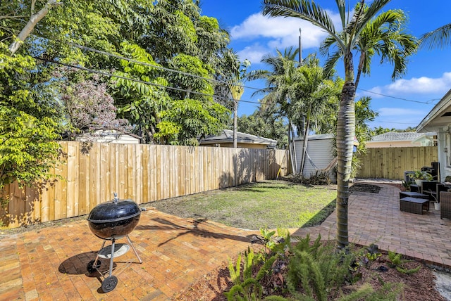 view of yard with a patio area, a shed, and a fire pit