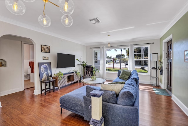 living room with ornamental molding and dark hardwood / wood-style floors