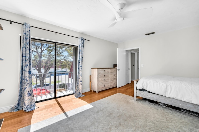 bedroom featuring wood-type flooring, access to exterior, and ceiling fan