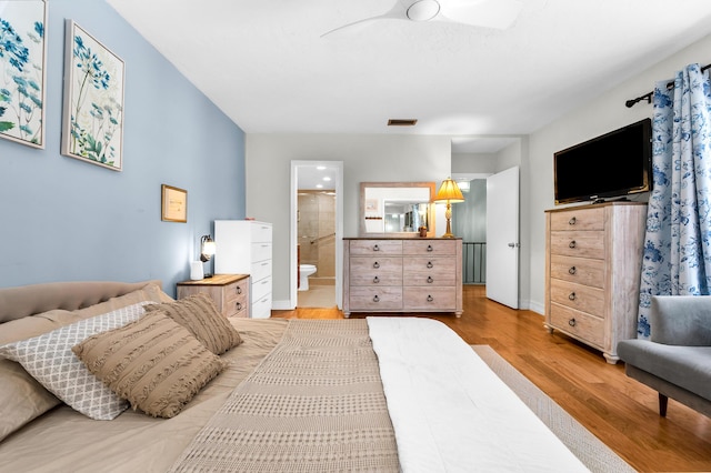 bedroom featuring hardwood / wood-style flooring and ensuite bath