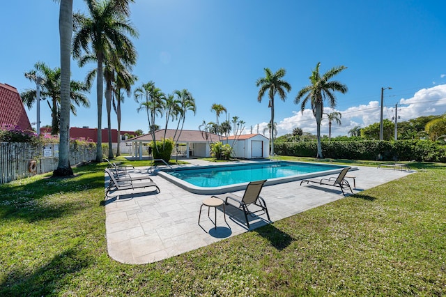 view of swimming pool with a storage unit, a yard, and a patio area