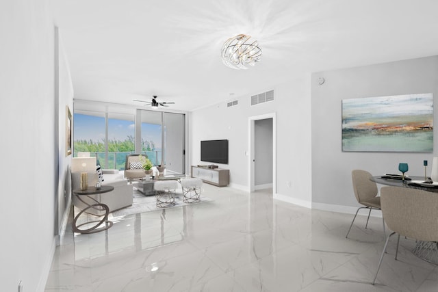 701 N Fort Lauderdale Beach Blvd Unit 504, Fort Lauderdale, FL 33304 - living area featuring marble finish flooring, a desk, a ceiling fan, and expansive windows