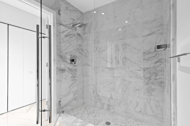 bathroom with a marble finish shower