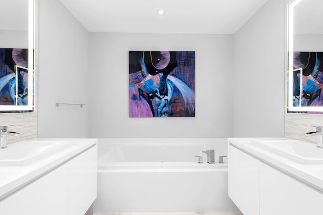 701 N Fort Lauderdale Beach Blvd Unit 504, Fort Lauderdale, FL 33304 - full bathroom featuring vanity, a garden tub, and decorative backsplash