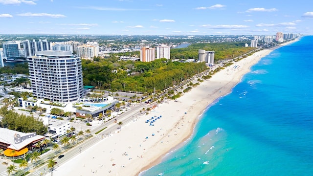 aerial view featuring a water view, a city view, and a beach view