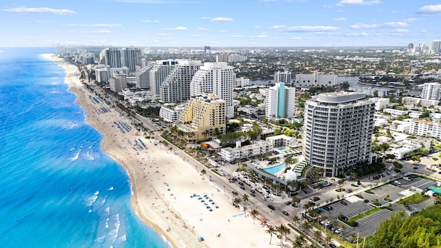 birds eye view of property with a city view, a view of the beach, and a water view