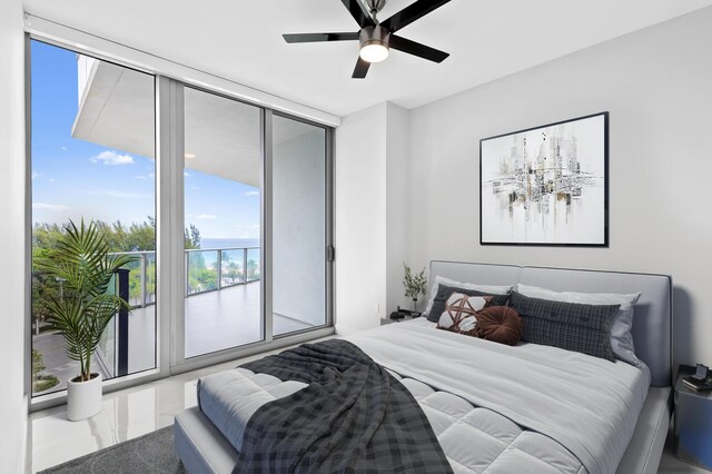 bedroom featuring expansive windows, access to exterior, and a ceiling fan