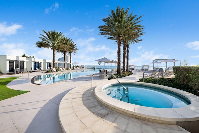 community pool with a patio and a community hot tub