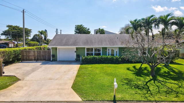 ranch-style house featuring a garage and a front yard