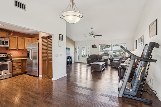 interior space featuring stainless steel appliances, dark hardwood / wood-style flooring, high vaulted ceiling, and hanging light fixtures