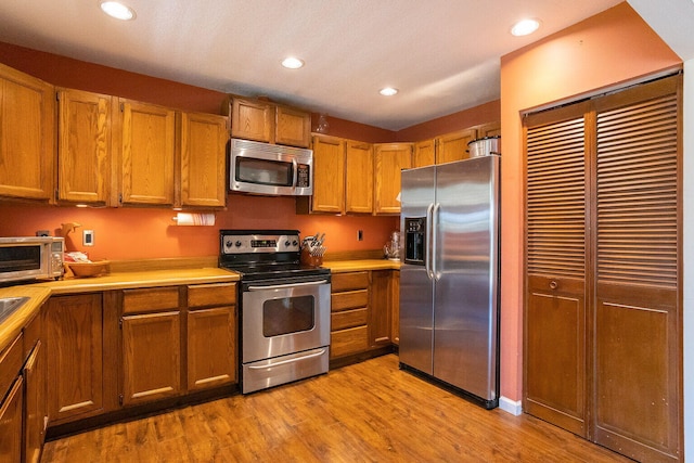 kitchen featuring appliances with stainless steel finishes and light wood-type flooring