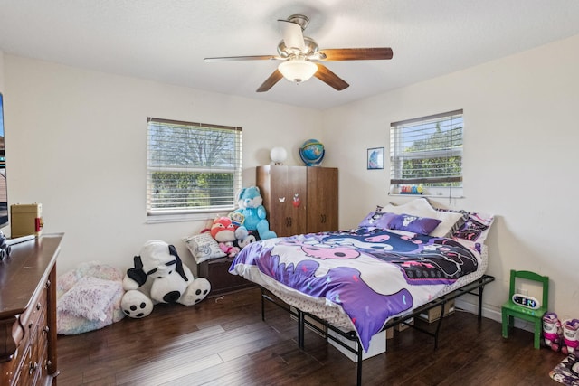 bedroom featuring multiple windows, ceiling fan, and dark hardwood / wood-style flooring