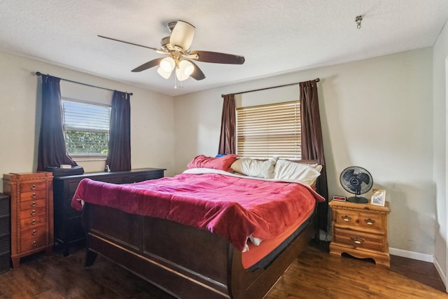 bedroom featuring ceiling fan, a textured ceiling, and dark hardwood / wood-style flooring