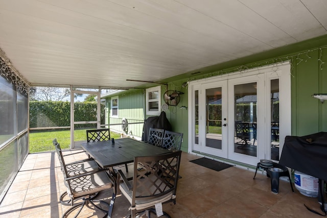 sunroom / solarium featuring french doors